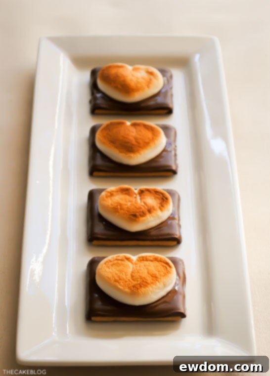 A tray of Heart Shaped S'more Cookies cooling after being broiled, showcasing their easy preparation.