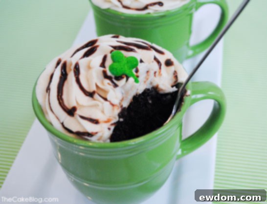 Indulgent Irish Coffee Cupcakes 5 Hand holding an Irish Coffee Cupcake, showcasing the creamy frosting and ganache drizzle, ready to be enjoyed