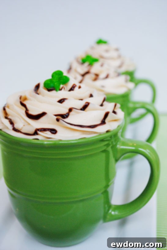 Indulgent Irish Coffee Cupcakes 6 Finished Irish Coffee Cupcake in a green mug, decorated with a shamrock and chocolate drizzle, ready to be enjoyed