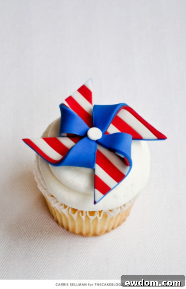 Closeup of patriotic pinwheel cupcakes with striped and polka dot fondant toppers in red, white, and blue