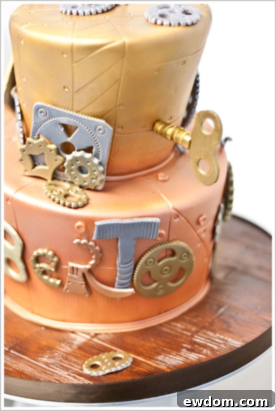 Robot Birthday Cake by Dream Day Cakes | TheCakeBlog.com Detailed shot of the Robot Birthday Cake's adorable robot topper, holding a mini cupcake with an infectious smile, by Dream Day Cakes.