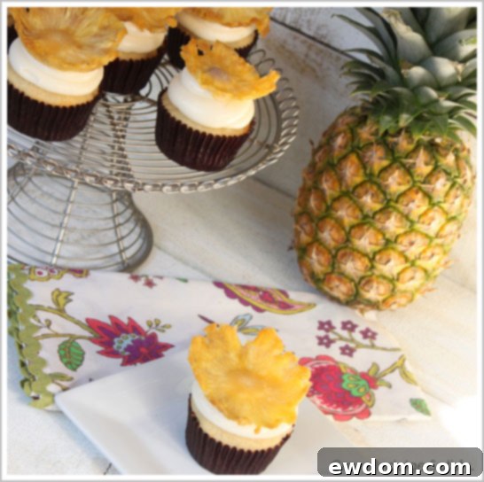 Close-up of a Tropical Pineapple Cupcake with a dried pineapple flower garnish | TheCakeBlog.com