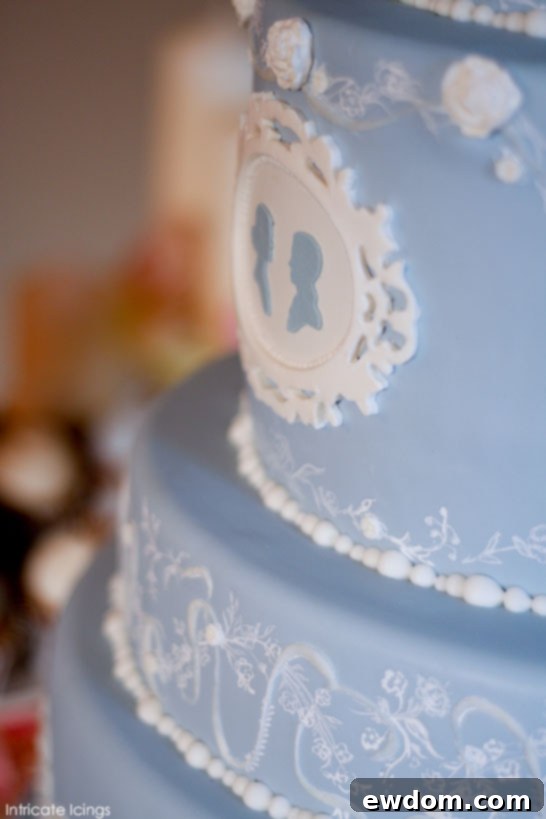 Elegant Cameo Confection 4 Intricate piping and blush floral accents on custom vintage cameo wedding cake