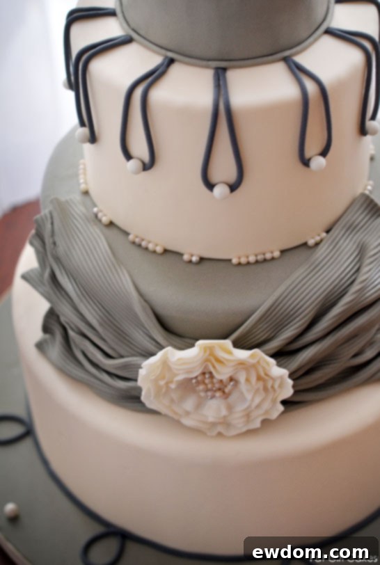 Textured Grey Sash with Fantasy Flower and Cascading Pearls on a White and Grey Cake by Fat Girl Cakes