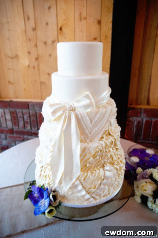 Side view highlighting the flowing sugar ruffles and elegant bow on the Intricate Icings cake