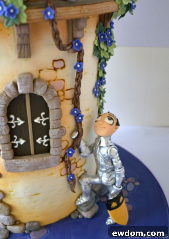 Close-up of the Rapunzel Cake's middle section, showcasing handcrafted details and figurines.