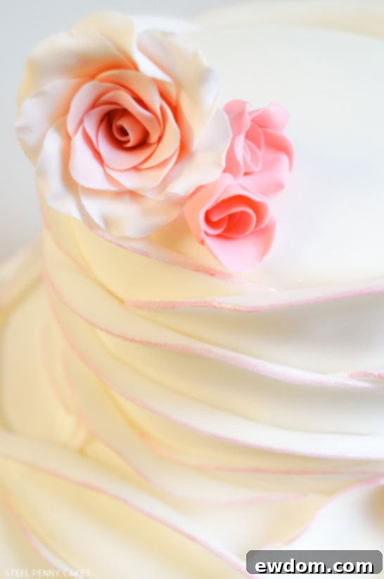 The intricate detail of the blush-edged fondant petals, an elegant wedding cake design by Steel Penny Cakes