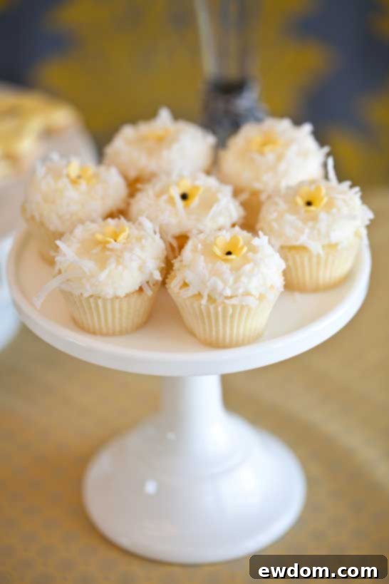 What Will It Bee? Baby Shower - Assortment of bee-themed vanilla cake lollipops and lemon macarons