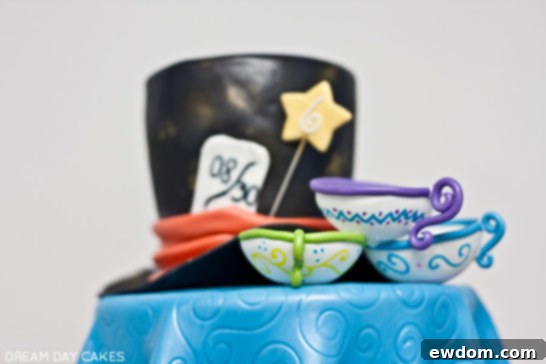 Close-up of the Mad Hatter's tea party on the Wonderland Cake, with edible teacups and fondant tablecloth