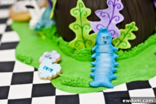 Side view of the Alice in Wonderland cake, showcasing the detailed edible elements