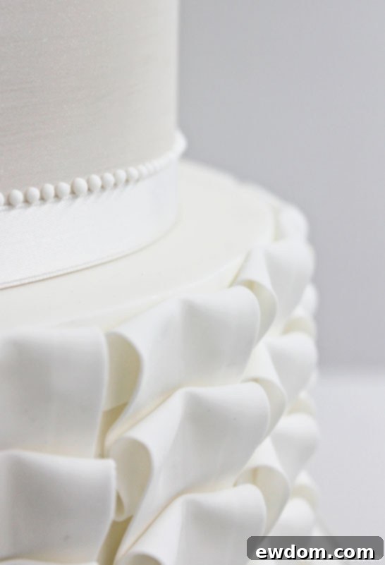 Elegant Four-Tier White Wedding Cake by Cove Cake Design