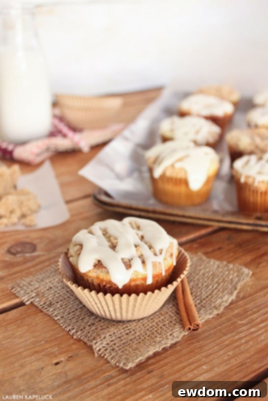 Cinnamon Swirl Delights 5 Finished Cinnamon Roll Cupcakes with vanilla glaze and streusel on a cooling rack