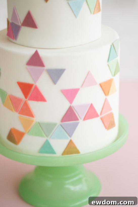 Detailed view of the cake's geometric pattern, highlighting the clean lines and soft pastel colors