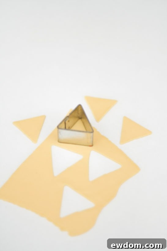 Close-up of handmade edible geometric toppers with gold painting, ready for cake insertion