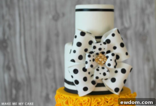 Detail of Black, White and Yellow Cake with Fondant Ruffles and Bow
