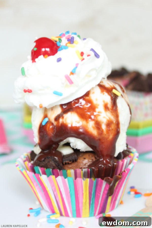 Decadent Brownie Sundae Cupcakes 4 A trio of perfectly arranged Brownie Cupcake Sundaes, showcasing various toppings.