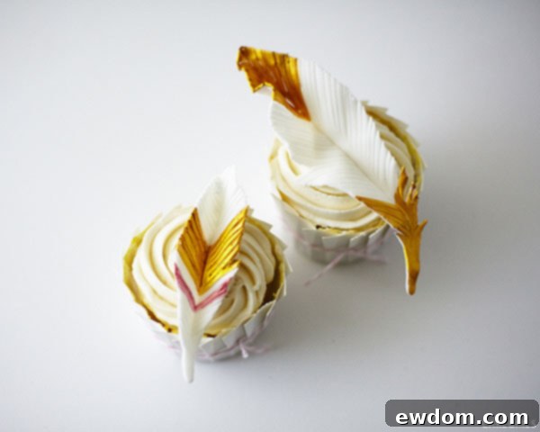 Finished gold feather cupcakes displayed on a tray for an event