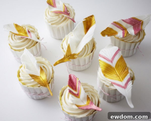 Close-up of elegant gold and coral feather cupcakes for a special event