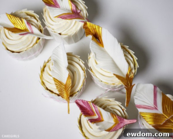 Variety of handmade gold feather cupcake toppers showing intricate details