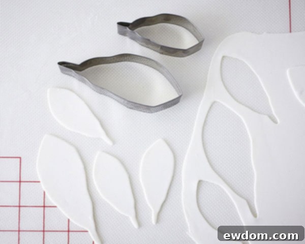 Process of cutting fondant feather shapes with a specialized cutter