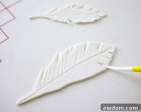Technique for cutting and separating fondant feather edges for realism