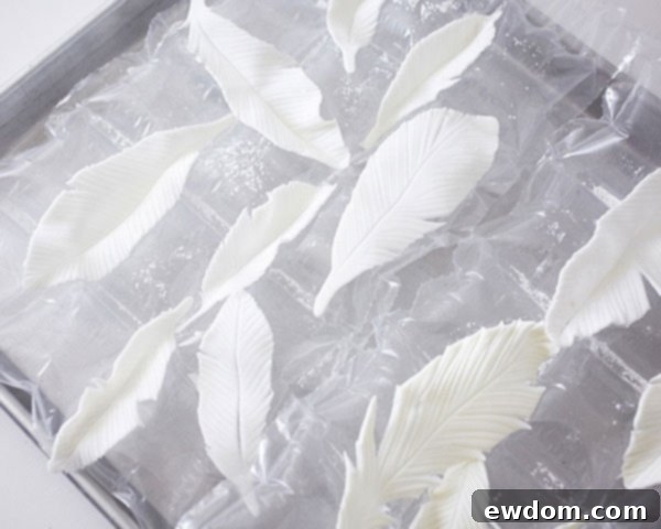 Fondant feathers drying on a textured surface to achieve a natural curve