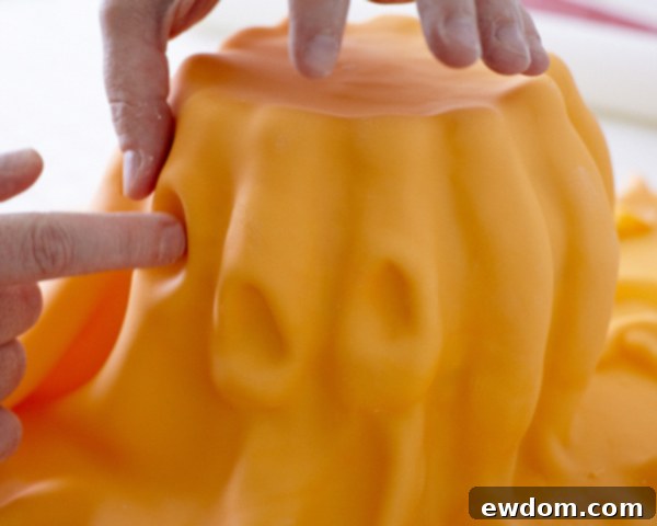 Covering a Sculpted Pumpkin Cake with Smooth Orange Fondant