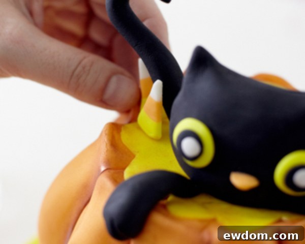 Finishing Touches: Fondant Dots, Candy Corn, and Wire Handle for Pumpkin Cake