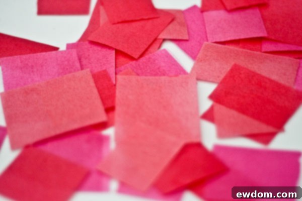 Detailed view of the edible wafer paper garland technique on the multi-tiered cake