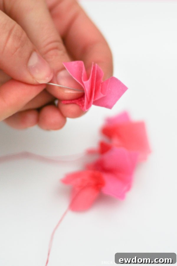 Final assembly of the exquisite edible paper garland on a multi-tiered celebration cake