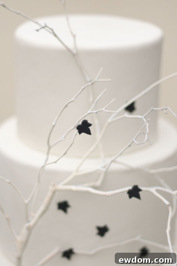 Elegant Ivory and Black Halloween Cake with Branches and Leaves