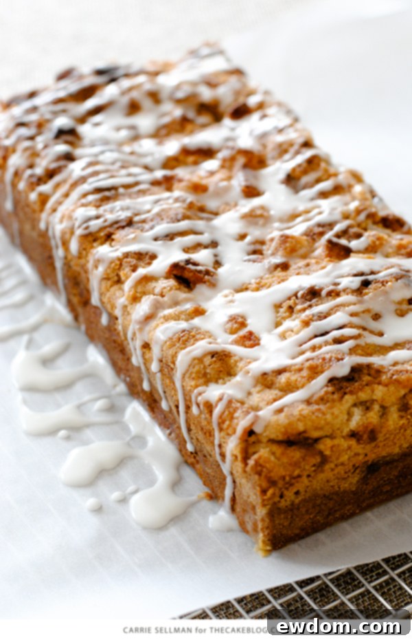 Finished Apple Crumb Cake drizzled with glaze, ready for serving with coffee or tea | Carrie Sellman for TheCakeBlog.com
