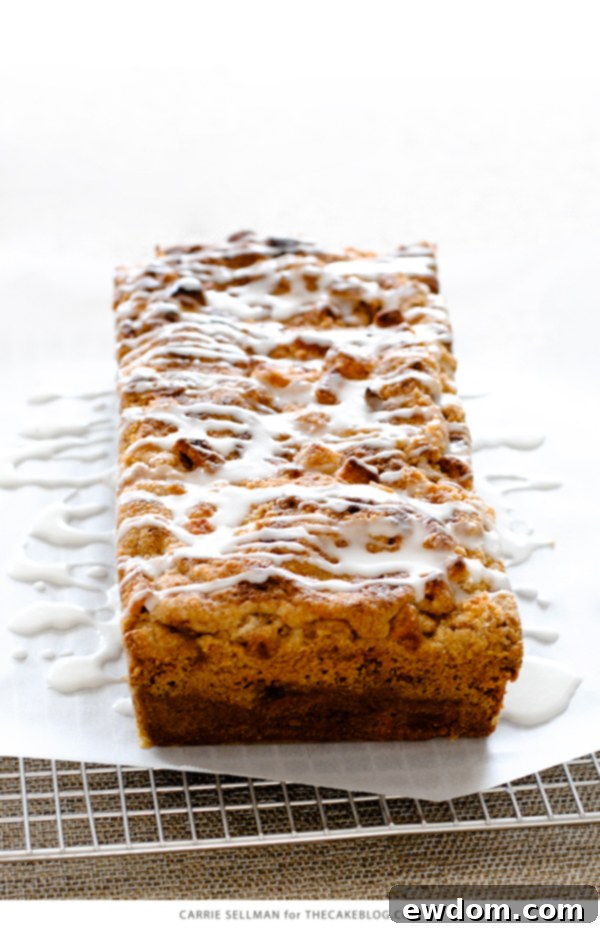 A close-up of a finished Apple Crumb Cake with glaze, highlighting the delightful streusel and inviting texture | Carrie Sellman for TheCakeBlog.com