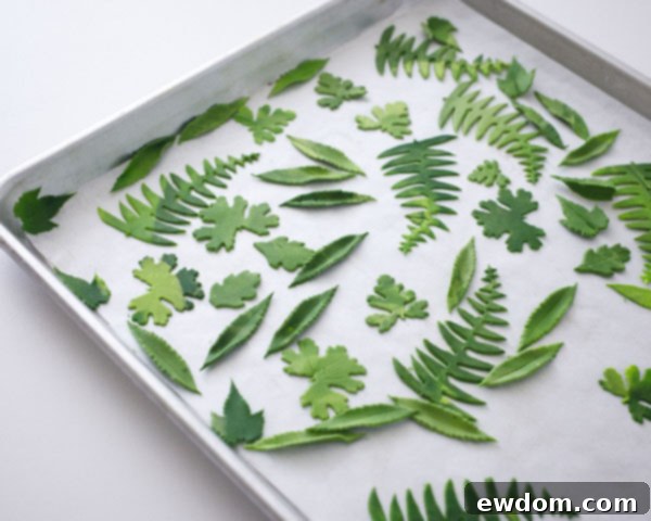 Sweet Little Worlds: DIY Cupcake Terrariums 11 Gum paste leaves drying on a parchment-covered tray for the cupcake terrarium.