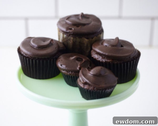 Sweet Little Worlds: DIY Cupcake Terrariums 13 Arranging various sized cupcakes, miniature deer, and edible leaves on the cake stand.