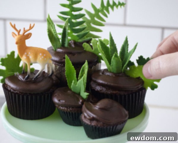 Sweet Little Worlds: DIY Cupcake Terrariums 14 Close-up of the initial arrangement of cupcakes, deer, and greenery in the terrarium.