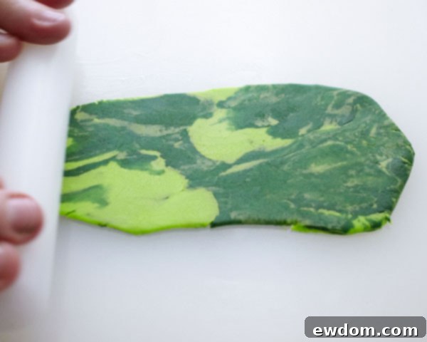 Sweet Little Worlds: DIY Cupcake Terrariums 9 Rolling out thinly marbled gum paste on a powdered sugar surface.