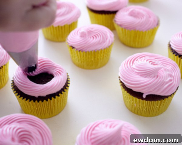 Decorating Christmas Cupcakes with pink icing for wreath assembly | Cakegirls