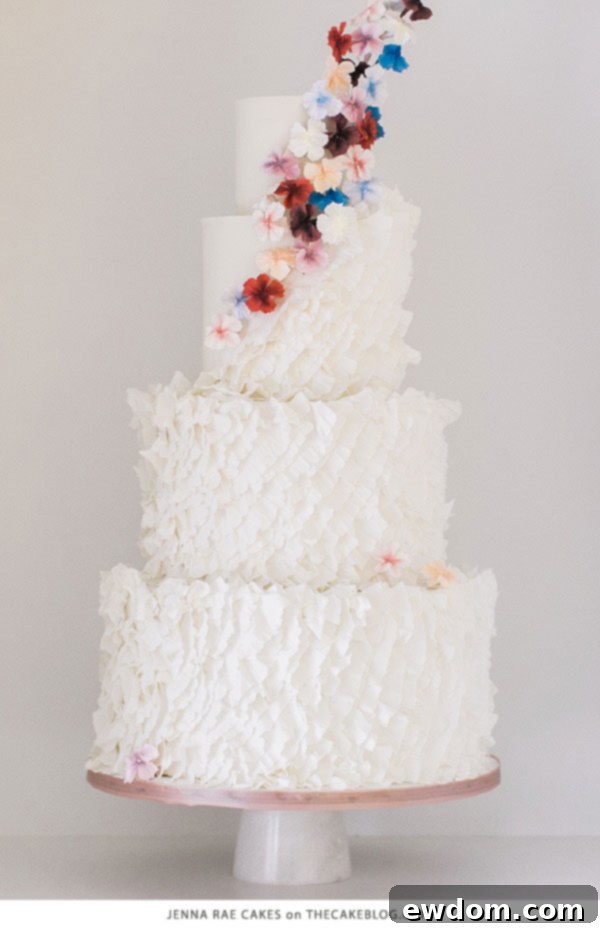 Jenna Rae Cakes Bakery Tour 7 A stunning wedding cake adorned with delicate, flowing ruffles, showcasing Jenna Rae Cakes' signature artistry.