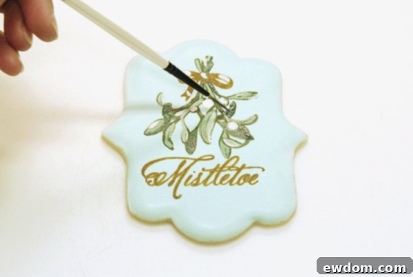 Mixing dark jade petal dust with oil and painting the leaf outlines and deeper areas