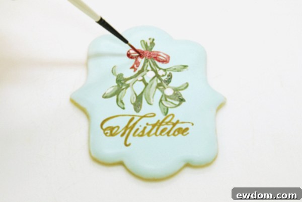 Painting a vibrant red bow with geranium red petal dust and blending for highlights