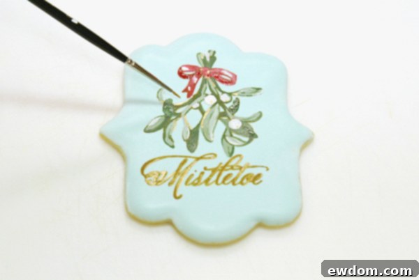 Adding optional gold powder dots to berries and highlights to leaves and text