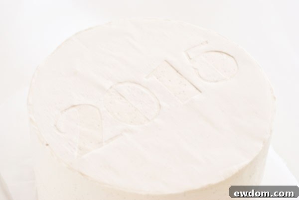 Sparkling Midnight Countdown Cake 14 Gently smoothing the stencil onto the cake for a flat surface