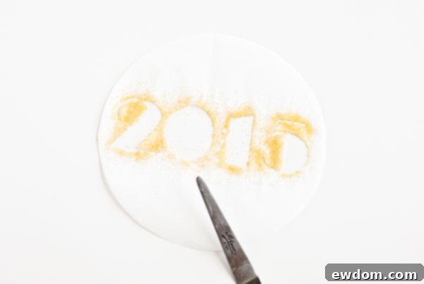 Sparkling Midnight Countdown Cake 19 Removing the stencil in one swift motion to reveal the sprinkle design