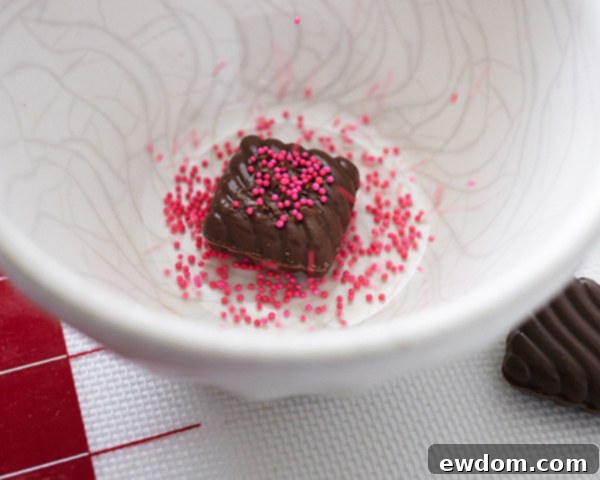 Valentines Candy Heart Surprise Cake 12 Close-up of decorated chocolate heart candies with a delicate heart sprinkle