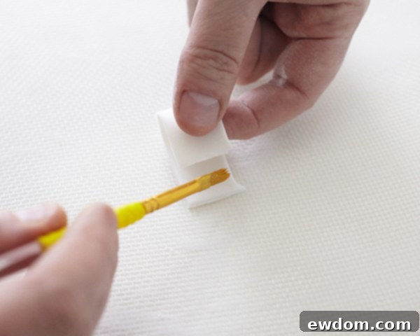 Valentines Candy Heart Surprise Cake 16 Folding a fondant segment in half to form a bow loop and securing with water