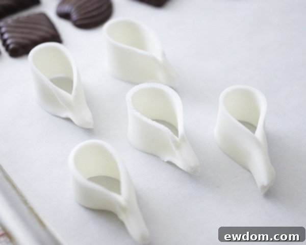 Valentines Candy Heart Surprise Cake 18 Arrangement of fondant bow loops drying on a tray for the cake decoration