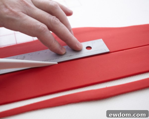 Valentines Candy Heart Surprise Cake 22 Measuring the side height of a heart-shaped cake for fondant strip application