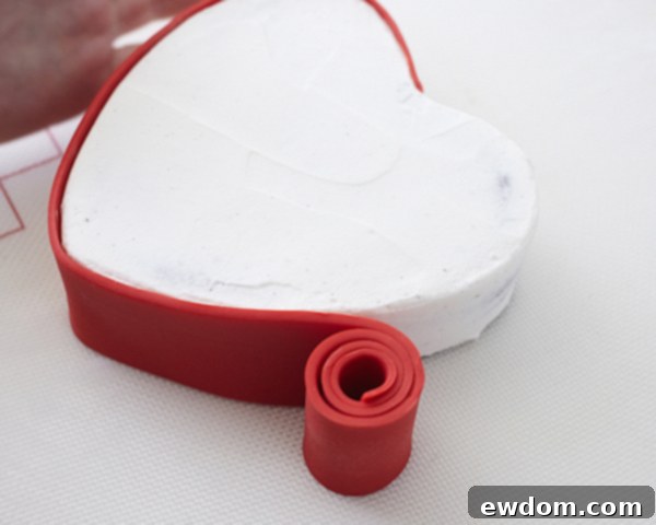 Valentines Candy Heart Surprise Cake 24 Smoothly wrapping red fondant around the entire side of the cake lid