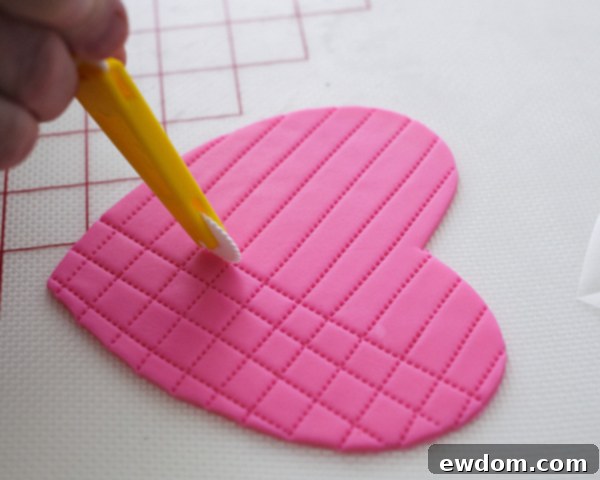 Valentines Candy Heart Surprise Cake 31 Creating a quilted pattern on the hot pink fondant heart with opposing stitching lines